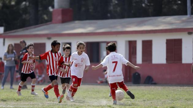 At age 7, Candelaria Cabrera goes after the ball with determination. She drives toward her rivals without caring much about getting hurt and deftly manages the bumps on the dirt field. She wears a loose white jersey from Huracan de Chabas, her hometown. Her long, copper coloured hair tied in a ponytail distinguishes her from the rest of the players. (Natacha Pisarenko / AP) At age 7, Candelaria Cabrera goes after the ball with determination. She drives toward her rivals without caring much about getting hurt and deftly manages the bumps on the dirt field. She wears a loose white jersey from Huracan de Chabas, her hometown. Her long, copper coloured hair tied in a ponytail distinguishes her from the rest of the players. (Natacha Pisarenko / AP)