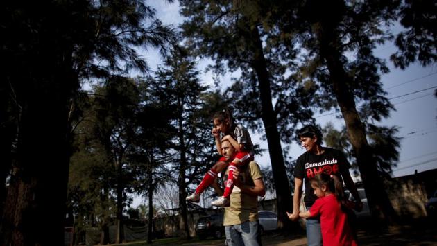 Candelaria Cabrera rides on the shoulders of her father, accompanied by her mother Rosana, and sister Rufina. “I had to sit down with her and tell her that there are some people who have to make rules in football and that these rules do not agree with what she wants,” said Rosana. “And, well, we both cried, and she said: ‘The people who make the laws are bad people.’” (Natacha Pisarenko / AP) Candelaria Cabrera rides on the shoulders of her father, accompanied by her mother Rosana, and sister Rufina. “I had to sit down with her and tell her that there are some people who have to make rules in football and that these rules do not agree with what she wants,” said Rosana. “And, well, we both cried, and she said: ‘The people who make the laws are bad people.’” (Natacha Pisarenko / AP)