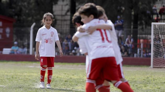 Candelaria watches her teammates celebrate a goal. She was 3 years old when her parents gave her her first ball. They understood that it didn’t make sense to insist she play with dolls, even if there were “comments from other moms that they should not give her male toys because it would encourage her to be a lesbian,” Noriega recalled. (Natacha Pisarenko / AP) Candelaria watches her teammates celebrate a goal. She was 3 years old when her parents gave her her first ball. They understood that it didn’t make sense to insist she play with dolls, even if there were “comments from other moms that they should not give her male toys because it would encourage her to be a lesbian,” Noriega recalled. (Natacha Pisarenko / AP)
