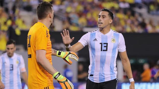 Argentina goalkeeper Franco Armani is congratulated by teamamte Ramiro Funes Mori after Armani made a stop in the first half against Colombia.(AFP)