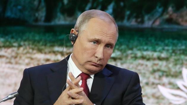 Vladimir Putin, Russia's president, listens via an earpiece during day two of the Eastern Economic Forum in Vladivostok, Russia, on Wednesday, Sept. 12, 2018.(Bloomberg)