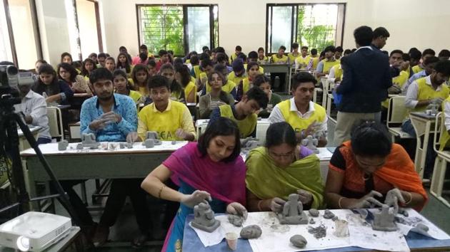 Environment Conservation Association and Pimpri-Chinchwad Municipal Corporation organises free training program to make ecofriendly Ganesh idols with clay in Nigidi, Pune. Students along with various members of different non-governmental organisations took part in the training. (HT PHOTO) Environment Conservation Association and Pimpri-Chinchwad Municipal Corporation organises free training program to make ecofriendly Ganesh idols with clay in Nigidi, Pune. Students along with various members of different non-governmental organisations took part in the training. (HT PHOTO)