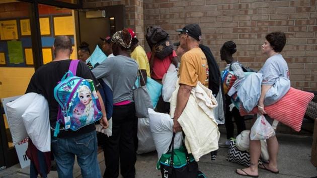 People line up to enter a hurricane shelter at Trask Middle School in wilmington, North Carolina, on September 11, 2018.(AFP)