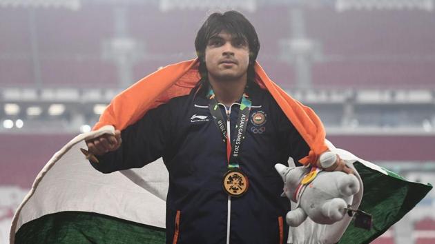 Gold medallist Neeraj Chopra celebrates during the victory ceremony for the men's javelin throw event during the 2018 Asian Games in Jakarta.(AFP)