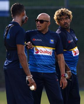Sri Lankan coach Chandika Hathurusingha (C) talks with Dasun Shanaka (L) as Lasith Malinga (R) looks on during a training session at the Dubai Sports city in Dubai. (AFP) Sri Lankan coach Chandika Hathurusingha (C) talks with Dasun Shanaka (L) as Lasith Malinga (R) looks on during a training session at the Dubai Sports city in Dubai. (AFP)