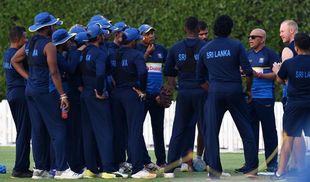 Sri Lankan coach Chandika Hathurusingha (3R) talks with team members during a training session at the Dubai Sports city in Dubai. (AFP) Sri Lankan coach Chandika Hathurusingha (3R) talks with team members during a training session at the Dubai Sports city in Dubai. (AFP)