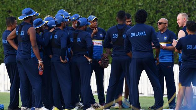 Sri Lankan coach Chandika Hathurusingha (3R) talks with team members during a training session at the Dubai Sports city in Dubai. (AFP)