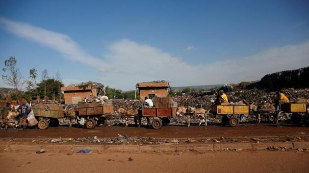 Donkey carts stand in line as they prepare to unload at a local waste transfer station. The population boom has made the issue of waste disposal in Bamako more acute, requiring Diabate’s boss, Moustapha Diarra, to deploy eight donkey carts in his district instead of the two he managed a decade ago. (Luc Gnago / REUTERS) 