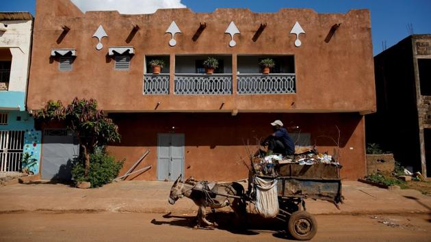A man who collects garbage using a donkey, drives his cart as he works in Bamako. The capital’s population more than quadrupled from the mid-1970s to 1.8 million as of 2009, according to census data. (Luc Gnago / REUTERS) 