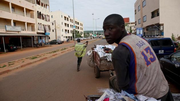 Arouna Diabate, 19, drives his cart as he works in Bamako. Every morning before dawn, Diabate hitches his donkey to a cart and sets off on his rounds, going door-to-door to collect household garbage. (Luc Gnago / REUTERS) 