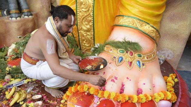 A priest offers prayers at the foot of a Ganesh idol. Recorded public celebrations of the festival date back to the Maratha empire in the 16th century. The festival in its present form saw resurgence under Bal Gangadhar Tilak as a rallying ground for people beyond caste and class lines and a means of spreading ideas of nationalism and a sense of unity. (Noah Seelam / AFP) A priest offers prayers at the foot of a Ganesh idol. Recorded public celebrations of the festival date back to the Maratha empire in the 16th century. The festival in its present form saw resurgence under Bal Gangadhar Tilak as a rallying ground for people beyond caste and class lines and a means of spreading ideas of nationalism and a sense of unity. (Noah Seelam / AFP)