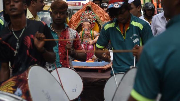 People play drums as they transport an idol for the Ganesh Chaturthi festival in Mumbai. On the final day, the idols are immersed in water (visarjan) to the chants of Ganpati Bappa Moraya, Pudhchya Varshi Lavkar Ya. (Punit Paranjpe / AFP) People play drums as they transport an idol for the Ganesh Chaturthi festival in Mumbai. On the final day, the idols are immersed in water (visarjan) to the chants of Ganpati Bappa Moraya, Pudhchya Varshi Lavkar Ya. (Punit Paranjpe / AFP)