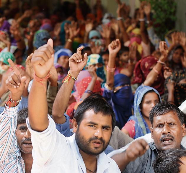 Around 100 sanitation workers gathered outside the MCG office near the Civil Hospital on Thursday to protest the poor working conditions.(Parveen Kumar/HT Photo)