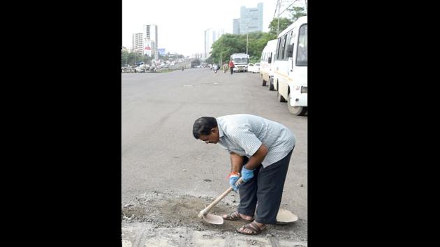 Bilhore said that the recognition of the work has given him strength to deal with the pain. “Wherever I go I feel Prakash is standing with me,” he said, adding, “As long as I am alive and can walk I will get rid of all of these potholes.” (Indranil Mukherjee / AFP)