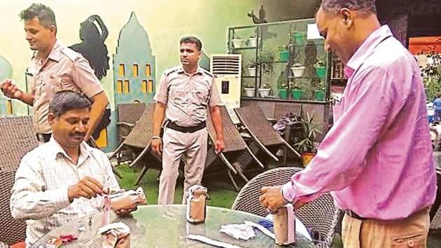 The raiding team collecting samples from Backyard Café in Sector 11, Panchkula, on Wednesday night. (HT Photo) The raiding team collecting samples from Backyard Café in Sector 11, Panchkula, on Wednesday night. (HT Photo)