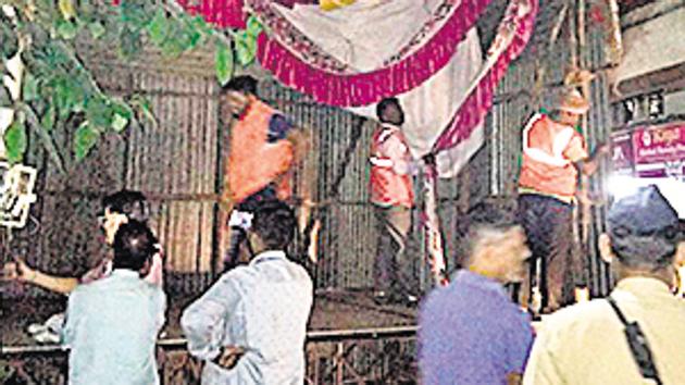 PMC anti-encroachment department officials and Mundhwa police station razed an illegal mandap for allegedly encroaching on over 60 per cent of road width in Ghorpadigaon. (HT PHOTO) PMC anti-encroachment department officials and Mundhwa police station razed an illegal mandap for allegedly encroaching on over 60 per cent of road width in Ghorpadigaon. (HT PHOTO)