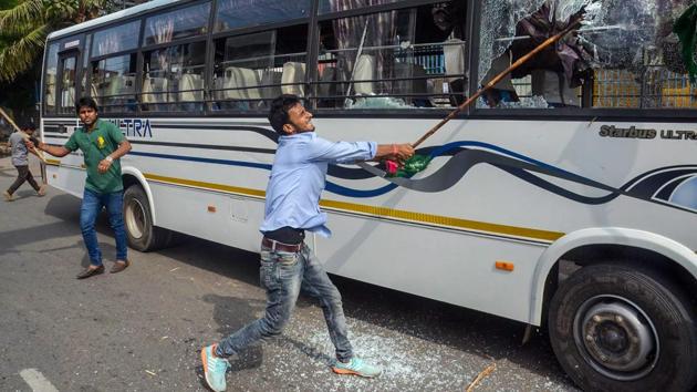 A Jan Adhikar Party supporter vandalises vehicles during ‘Bharat Bandh’ protest against fuel price hike and depreciation of the rupee in Patna, Bihar on September 10, 2018. (PTI) 