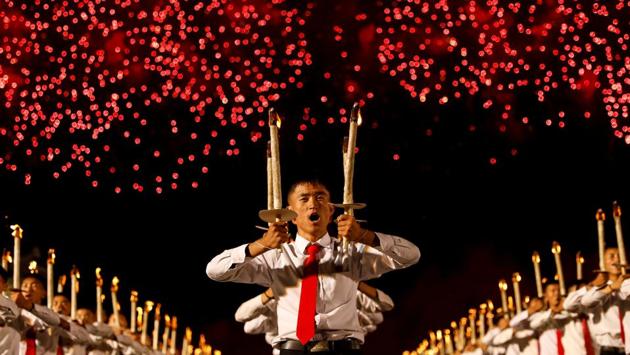 Fireworks explode over participants during a torchlight procession during the celebration marking the 70th anniversary of North Korea's foundation in Pyongyang, North Korea. (Danish Siddiqui / REUTERS)