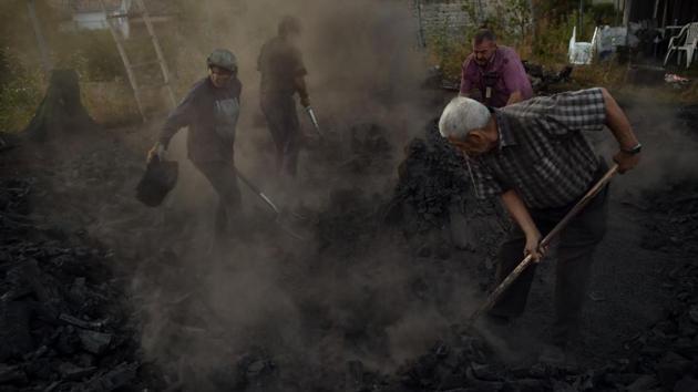 Workers extinguish the fire of burning tree trunks. Galdeano abandoned the trade for two decades when he joined scores of other peasants who sought jobs in bigger cities. But when Basque steel mills downsized in the late 1970s, Galdeano returned to Viloria and its surrounding mountains to keep making charcoal. (Alvaro Barrientos / AP) Workers extinguish the fire of burning tree trunks. Galdeano abandoned the trade for two decades when he joined scores of other peasants who sought jobs in bigger cities. But when Basque steel mills downsized in the late 1970s, Galdeano returned to Viloria and its surrounding mountains to keep making charcoal. (Alvaro Barrientos / AP)