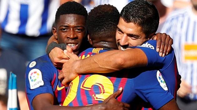 Barcelona's Luis Suarez celebrates scoring their first goal with team mates against Real Sociedad.(REUTERS)