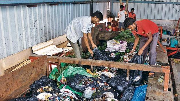 The practice of compacting waste by mixing it at the transfer stations, according to environmentalists and experts, is in violation of the Solid Waste Management Rules, notified by the ministry of environment and forests in 2016. (HT Photo) The practice of compacting waste by mixing it at the transfer stations, according to environmentalists and experts, is in violation of the Solid Waste Management Rules, notified by the ministry of environment and forests in 2016. (HT Photo)