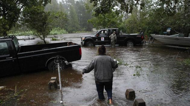 A resident walks from her flooded house towards the crew of the Cajun Navy in Lumberton, North Carolina, on September 15, 2018 in the wake of Hurricane Florence.(AFP) A resident walks from her flooded house towards the crew of the Cajun Navy in Lumberton, North Carolina, on September 15, 2018 in the wake of Hurricane Florence.(AFP)