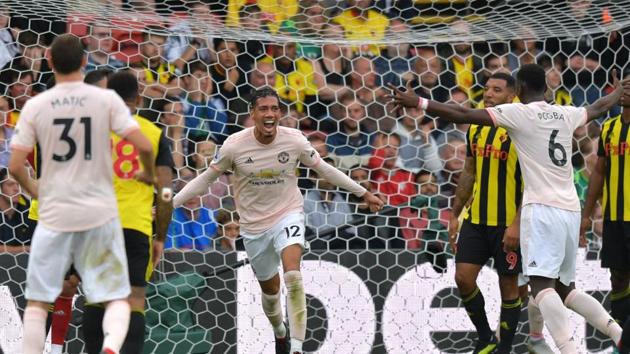 Manchester United's English defender Chris Smalling celebrates after scoring their second goal during the English Premier League football match between Watford and Manchester United.(AFP)