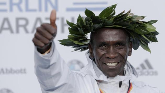 Gold medalist Eliud Kipchoge celebrates during the winning ceremony for the 45th Berlin Marathon in Berlin.(AP)