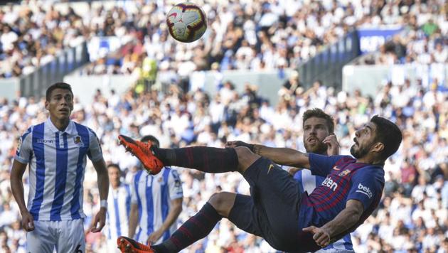 FC Barcelona's Luis Suarez attempts an overhead kick during the Spanish La Liga soccer match between Real Sociedad and FC Barcelona.(AP)