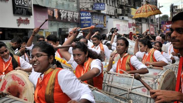 The dhol is often known as a mangal vadya (celebratory instrument) as well as ran vadya (instrument fro encouragement during a battle). Women perform in a sequence playing dhol’s during Ganpati festival procession on Laxmi road in Pune. (HT PHOTO) 