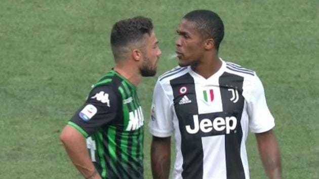 Juventus forwards Douglas Costa caught spitting in the face of Sassuolo’s Federico Di Francesco.(Twitter)