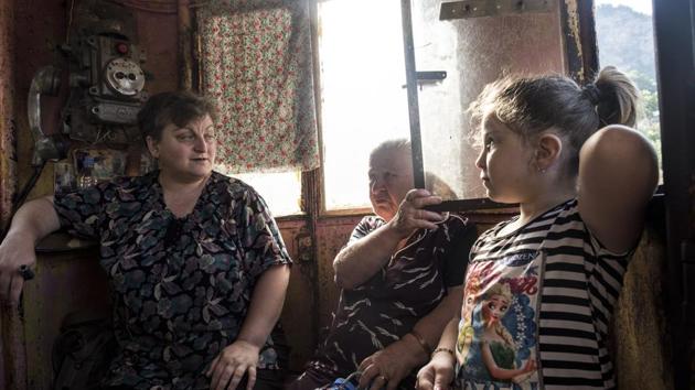 Local residents talk to each other as they ride in a cable car. But if the 64-year-old transit system looks like a wild ride to an outsider, Chiatura’s people seem to take the creaking cars and precipitous drops in stride. (Evgeniy Maloletka / AP) Local residents talk to each other as they ride in a cable car. But if the 64-year-old transit system looks like a wild ride to an outsider, Chiatura’s people seem to take the creaking cars and precipitous drops in stride. (Evgeniy Maloletka / AP)
