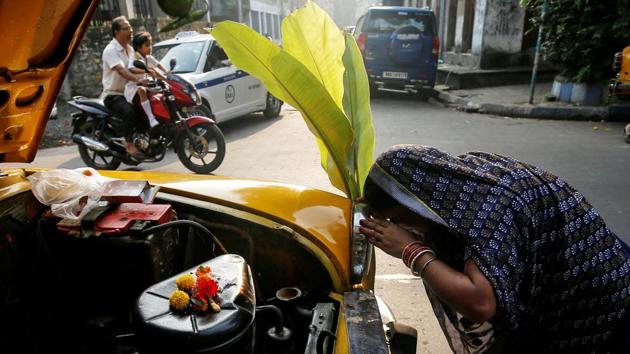 A taxi driver’s wife offers prayers in front of their taxi during Vishwakarma Puja, a festival of the Hindu deity of architecture and machinery in Kolkata on Monday. Craftsmen believe that the creation of their tools was due to Vishwakarma, which is why on this day they worship the tools of their trade. (Rupak De Chowdhuri / REUTERS) A taxi driver’s wife offers prayers in front of their taxi during Vishwakarma Puja, a festival of the Hindu deity of architecture and machinery in Kolkata on Monday. Craftsmen believe that the creation of their tools was due to Vishwakarma, which is why on this day they worship the tools of their trade. (Rupak De Chowdhuri / REUTERS)