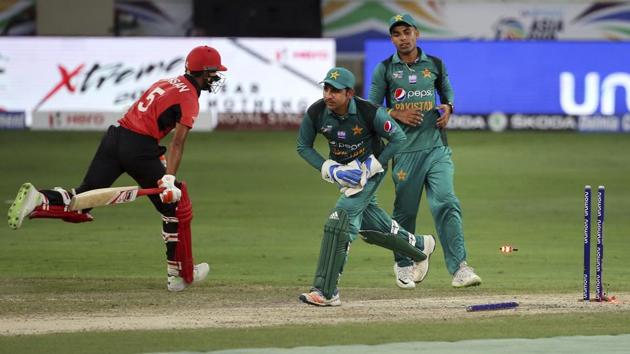 Pakistan's captain Sarfraz Ahmed, center, runs to celebrate after dislodging the bails to dismiss Hong Kong's Ehsan Nawaz, left, during the one day international cricket match of Asia Cup between Pakistan and Hong Kong in Dubai, United Arab Emirates, Sunday, Sept. 16, 2018. (AP) Pakistan's captain Sarfraz Ahmed, center, runs to celebrate after dislodging the bails to dismiss Hong Kong's Ehsan Nawaz, left, during the one day international cricket match of Asia Cup between Pakistan and Hong Kong in Dubai, United Arab Emirates, Sunday, Sept. 16, 2018. (AP)