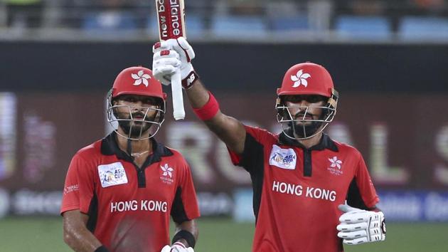 Hong Kong's captain Anshuman Rath, left, watches as teammate Nizakat Khan raises his bat to celebrate scoring fifty. (AP)