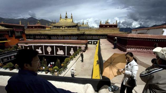 Tourists visit the Jokhang Monastery, one of the oldest Tibetan monasteries in Lhasa in the Tibet Autonomous Region.(AP File Photo)