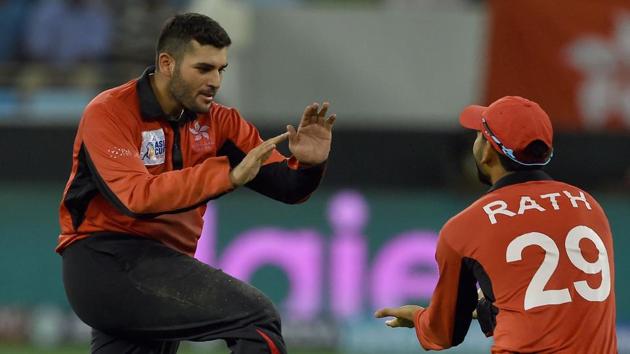 Hong Kong team captain Anshuman Rath (R) and Kinchit Shah celebrates after dismissing Indian batsman Dinesh Karthik. (AFP)