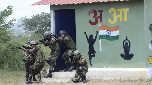 Troops come out after a search operation during an exercise in Pune. (Ravindra Joshi/HT PHOTO) 