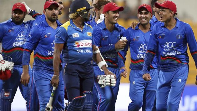 Afghanistan's Mujeeb Ur Rahman, right, shares a light moment with Sri Lanka's Lasith Malinga, center wearing helmet, as they leave the field at the end of the one day international cricket match. (AP) Afghanistan's Mujeeb Ur Rahman, right, shares a light moment with Sri Lanka's Lasith Malinga, center wearing helmet, as they leave the field at the end of the one day international cricket match. (AP)