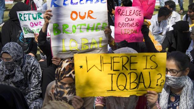 Students of Sher-e- Kashmir Institute of Medical Science (SKIMS) raise placards during a silent protest, demanding the release of their colleague Mohammad Iqbal who was arrested by police in Jhajjar Kotli incident last week, in Srinagar. (PTI) Students of Sher-e- Kashmir Institute of Medical Science (SKIMS) raise placards during a silent protest, demanding the release of their colleague Mohammad Iqbal who was arrested by police in Jhajjar Kotli incident last week, in Srinagar. (PTI)