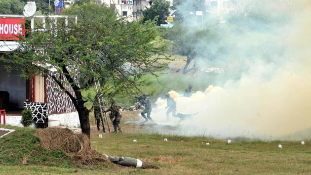 Troops create a smoke screen in order to help other troops cordon the target area during the validation exercise at Aundh Military Station.  (HT photo) 