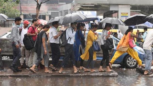 Commuters shelter under umbrellas as they walk through a water logged street during rain at Kashmiri gate in New Delhi, India, on Wednesday, September 05, 2018.(HT File Photo)