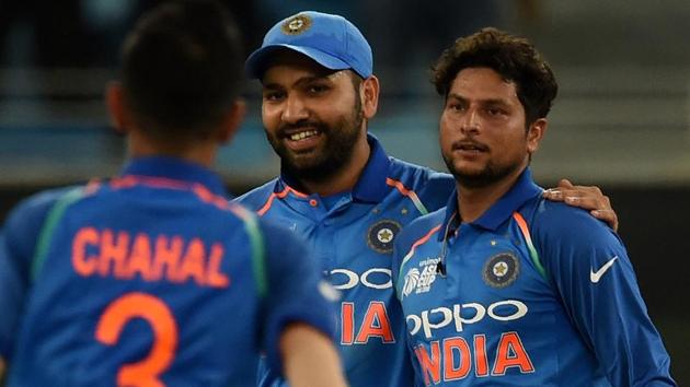 Indian cricket team captain Rohit Sharma (C) celebrates with teammate Kuldeep Yadav (R) after dismissing Hong Kong team captain. (AFP)