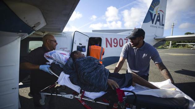 Paramedics wheel Sandra Medina to a plane at the airport in Vieques. At first the Federal Emergency Management Agency (FEMA) assumed responsibility, flying patients to San Juan. After a month, FEMA withdrew and non-profits picked up the bill. Since March, the Renal Council has been paying for travel and food. However, the council has said it will run out of money to do so by month’s end. (Carlos Giusti / AP) 