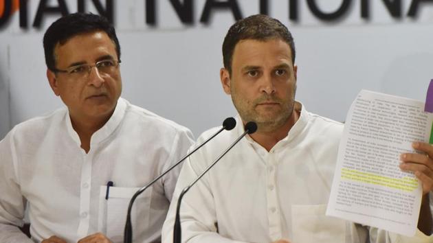 Congress president Rahul Gandhi with party spokesperson Rajdeep Surjewala shows a document during a press conference on demonetisation and Rafale Deal, at AICC headquarters in New Delhi. (Vipin Kumar/HT PHOTO) Congress president Rahul Gandhi with party spokesperson Rajdeep Surjewala shows a document during a press conference on demonetisation and Rafale Deal, at AICC headquarters in New Delhi. (Vipin Kumar/HT PHOTO)