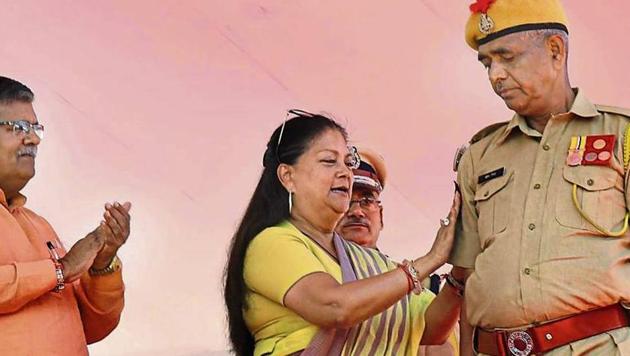 Chief minister Vasundhara Raje straps a badge on the arm of a policeman at a promotion ceremony for constables in Jaipur on Wednesday.(PRABHAKAR SHARMA/HT PHOTO) Chief minister Vasundhara Raje straps a badge on the arm of a policeman at a promotion ceremony for constables in Jaipur on Wednesday.(PRABHAKAR SHARMA/HT PHOTO)