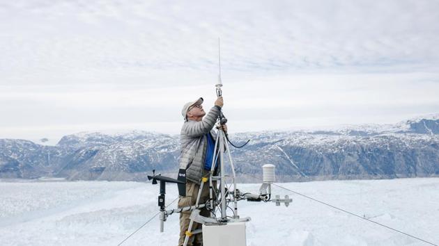 NYU oceanographer David Holland repairs a broken GPS module at his research camp above the Helheim glacier. Holland gathered data on seismic activity, temperature and wind, along with and time-lapse pictures. (Lucas Jackson / REUTERS) NYU oceanographer David Holland repairs a broken GPS module at his research camp above the Helheim glacier. Holland gathered data on seismic activity, temperature and wind, along with and time-lapse pictures. (Lucas Jackson / REUTERS)