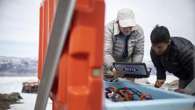 David Holland works with student Febin Magar to inspect a seismograph in their science camp. The OMG project aims to clarify how Greenland itself contributes to rising seas, but also to apply that knowledge to the study of the much larger region of Antarctica, which has far more ice and could ultimately play a much bigger role in sea-level rise. (Lucas Jackson / REUTERS) David Holland works with student Febin Magar to inspect a seismograph in their science camp. The OMG project aims to clarify how Greenland itself contributes to rising seas, but also to apply that knowledge to the study of the much larger region of Antarctica, which has far more ice and could ultimately play a much bigger role in sea-level rise. (Lucas Jackson / REUTERS)