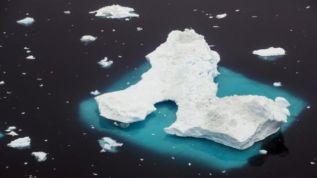 An iceberg floats in a fjord near the town of Tasiilaq, Greenland. Perched on a cliff above Greenland’s Helheim glacier, Reuters photographer Lucas Jackson tried calling his wife in New York on a satellite phone. Before he could leave a message, an explosion broke the arctic silence. (Lucas Jackson / REUTERS) An iceberg floats in a fjord near the town of Tasiilaq, Greenland. Perched on a cliff above Greenland’s Helheim glacier, Reuters photographer Lucas Jackson tried calling his wife in New York on a satellite phone. Before he could leave a message, an explosion broke the arctic silence. (Lucas Jackson / REUTERS)
