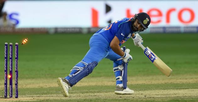 Indian cricket team captain Rohit Sharma looks back towards his wicket as he is dismissed by Pakistan bowler Shadab Khan. (AFP)